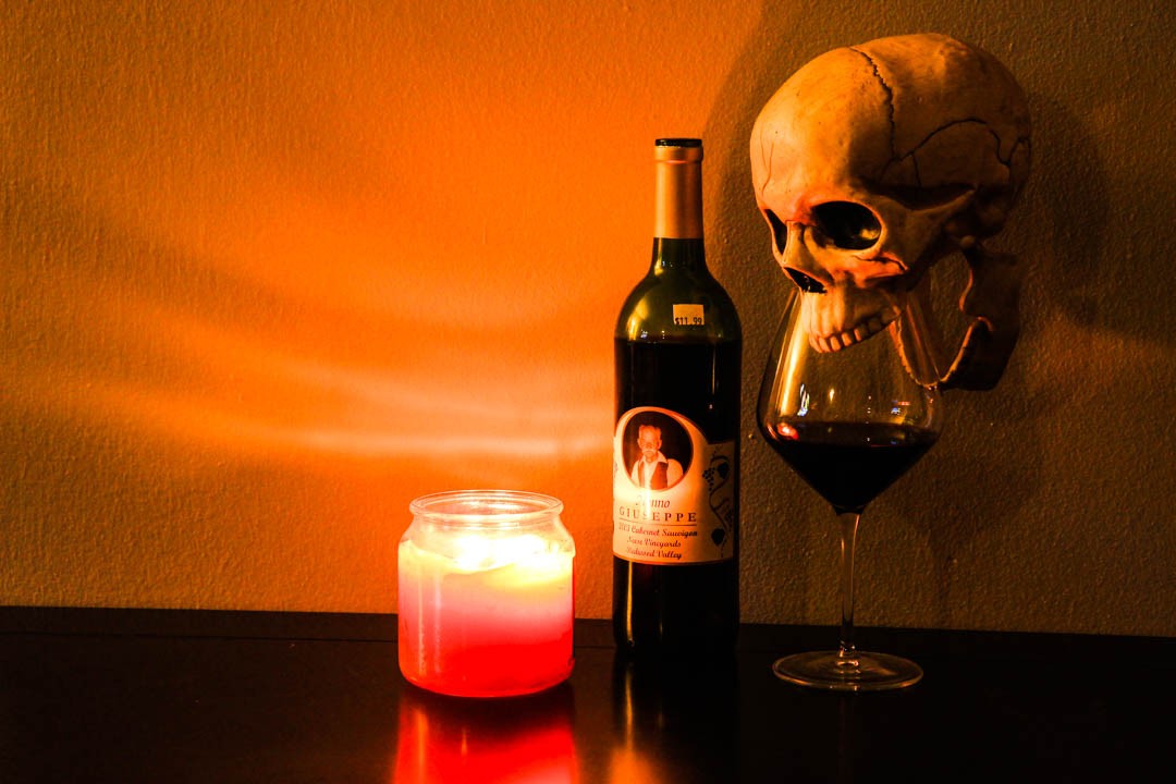 Skull drinking a glass of red wine