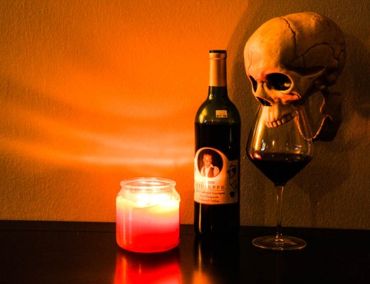 Skull drinking a glass of red wine